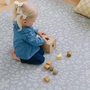 Baby playing on PopsyKosy Tranquil Flower Gray EVA foam mat in modern living room